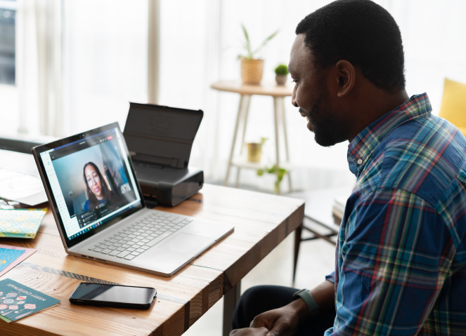 Young Black man in home setting having a video chat call with a woman